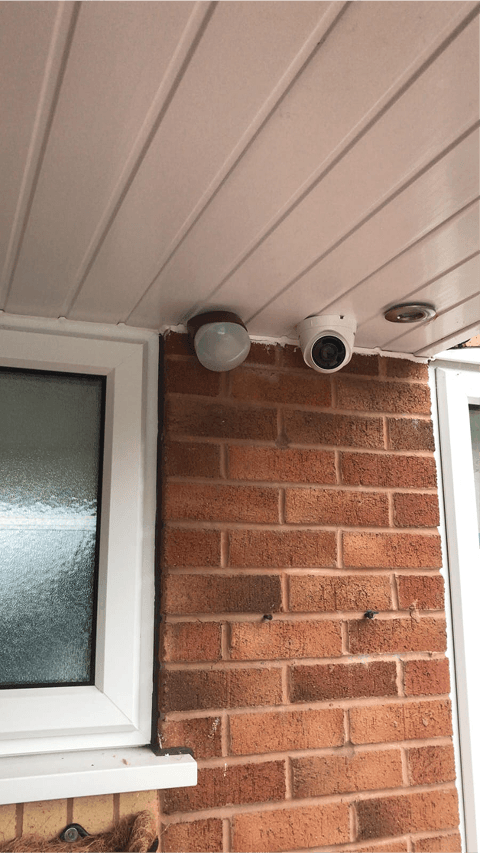 A high-definition CCTV camera mounted on a modern commercial building in Warrington.