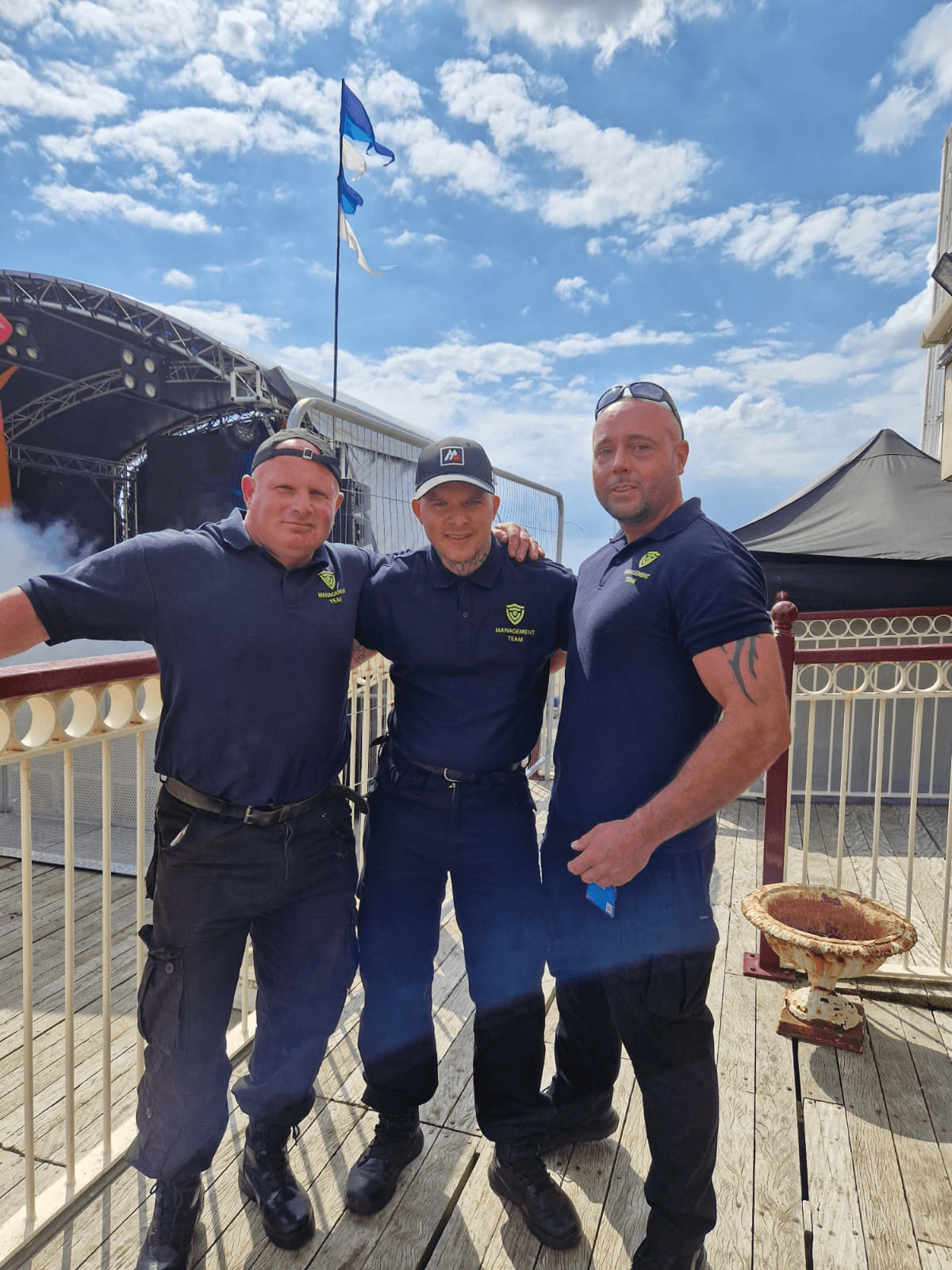 A team of professional event security guards coordinating at a large outdoor festival.